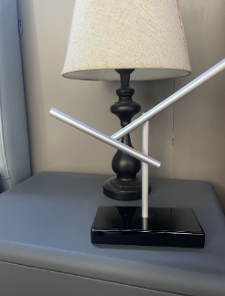 The original product photograph shows moving rods on a black base, displayed as a desktop ornament.
